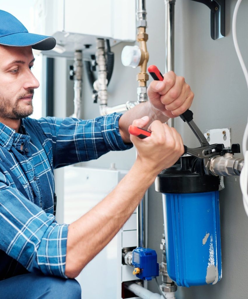 young-plumber-or-technician-installing-or-repairing-system-of-water-filtration.jpg