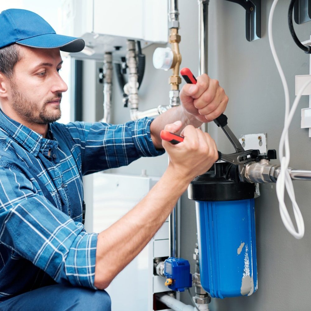 young-plumber-or-technician-installing-or-repairing-system-of-water-filtration.jpg